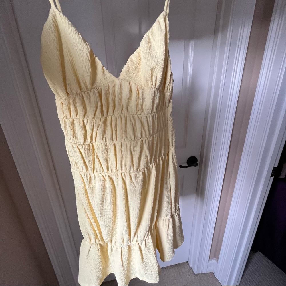 Lemon yellow mini sundress with adjustable spaghetti straps. Size small.